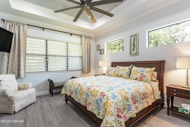 bedroom featuring ceiling fan, crown molding, and hardwood / wood-style flooring