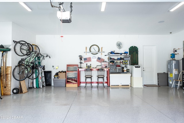 garage with a workshop area, electric water heater, and a garage door opener