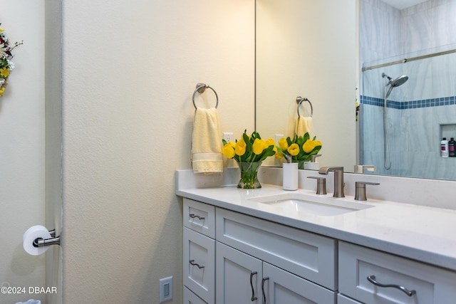 bathroom featuring vanity and tiled shower