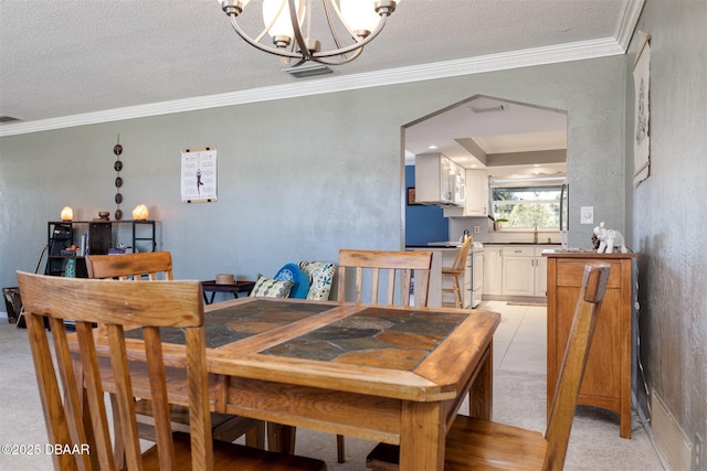 dining room with visible vents, a textured ceiling, an inviting chandelier, and ornamental molding