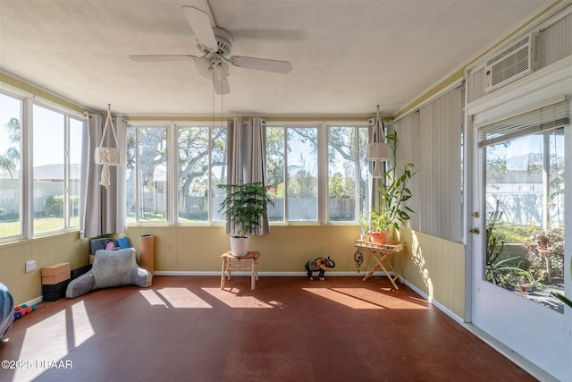 unfurnished sunroom featuring plenty of natural light and a ceiling fan