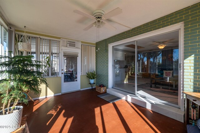 unfurnished sunroom featuring a ceiling fan