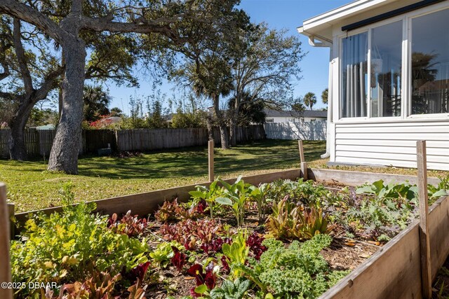 view of yard with a fenced backyard and a vegetable garden