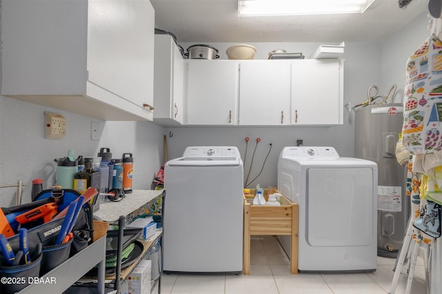 clothes washing area featuring cabinet space, light tile patterned flooring, separate washer and dryer, and water heater