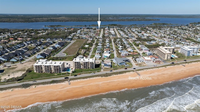 bird's eye view featuring a water view and a beach view