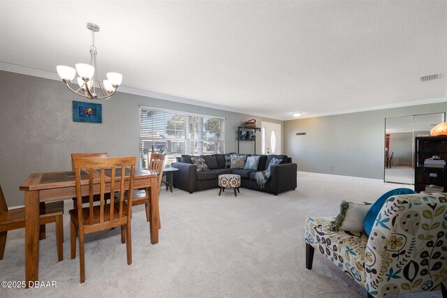 dining area with visible vents, baseboards, crown molding, a notable chandelier, and light colored carpet