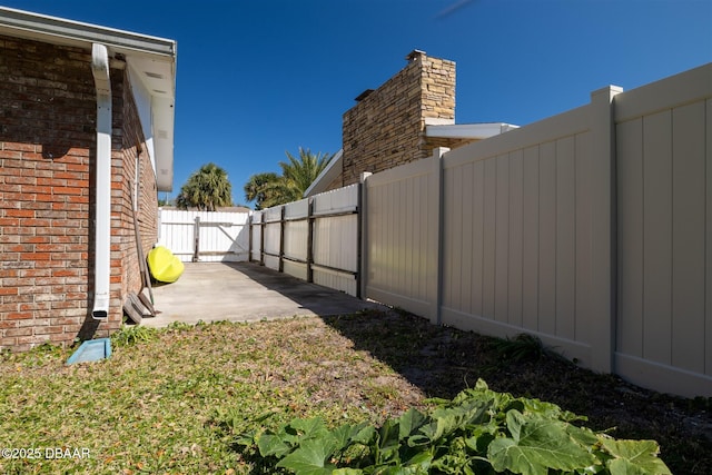 view of yard featuring a patio and fence