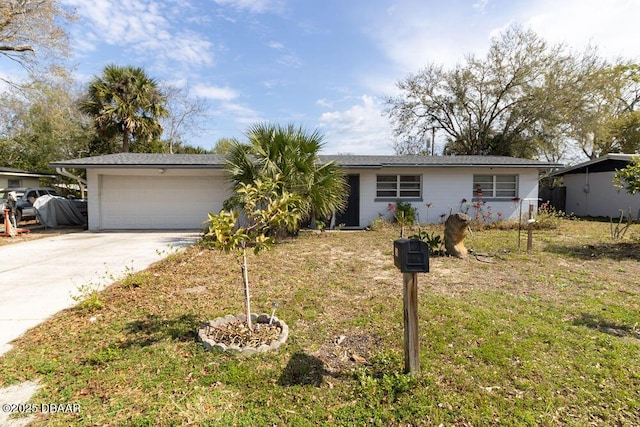 single story home with a garage, a front yard, and driveway