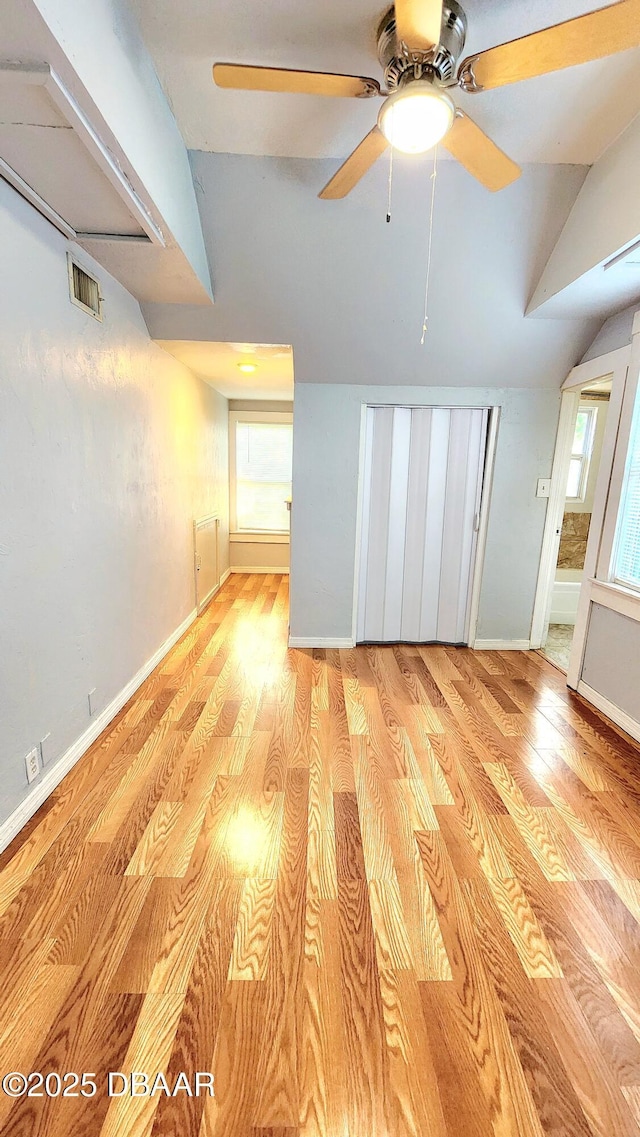 524 W St, Daytona Beach, FL 32114 - unfurnished living room featuring vaulted ceiling, light wood-style floors, plenty of natural light, baseboards, and ceiling fan