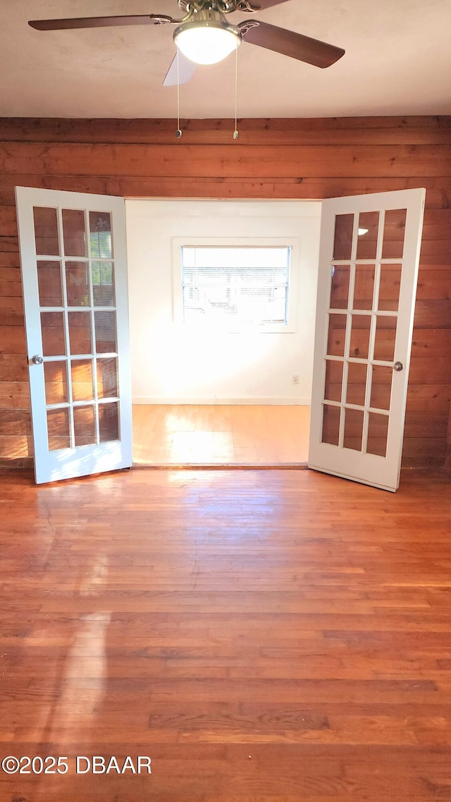 524 W St, Daytona Beach, FL 32114 - spare room with ceiling fan, wood finished floors, healthy amount of natural light, and wooden walls