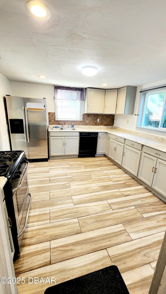 524 W St, Daytona Beach, FL 32114 - kitchen featuring stainless steel appliances, light countertops, and a sink
