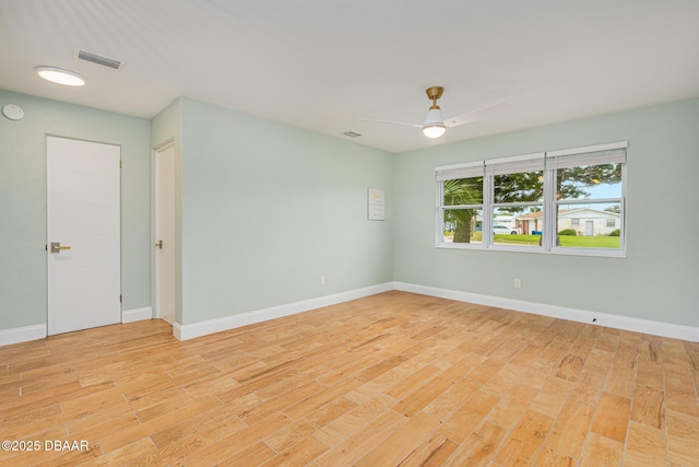 unfurnished room with ceiling fan and light wood-type flooring