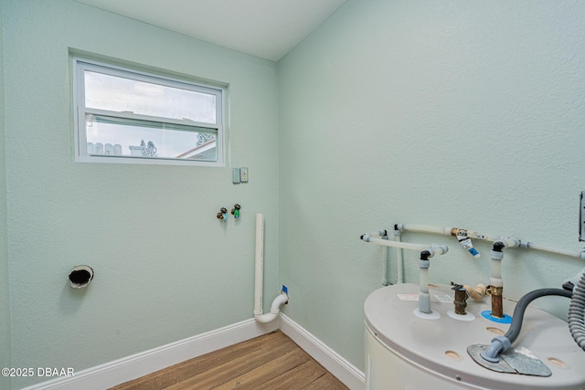 bathroom with water heater and wood-type flooring