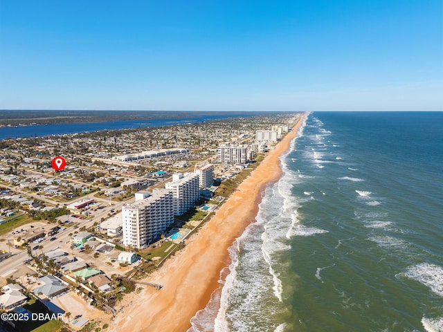 drone / aerial view with a water view and a beach view