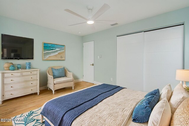 empty room with ceiling fan and light hardwood / wood-style floors