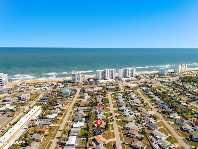 drone / aerial view featuring a water view and a view of the beach