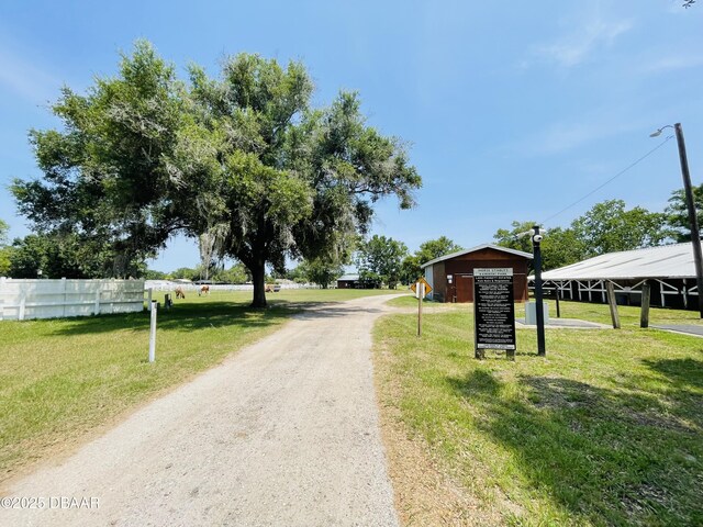 3565 E Lake Dr, Land Olakes, FL 34639 - view of dirt / gravel road with street lighting