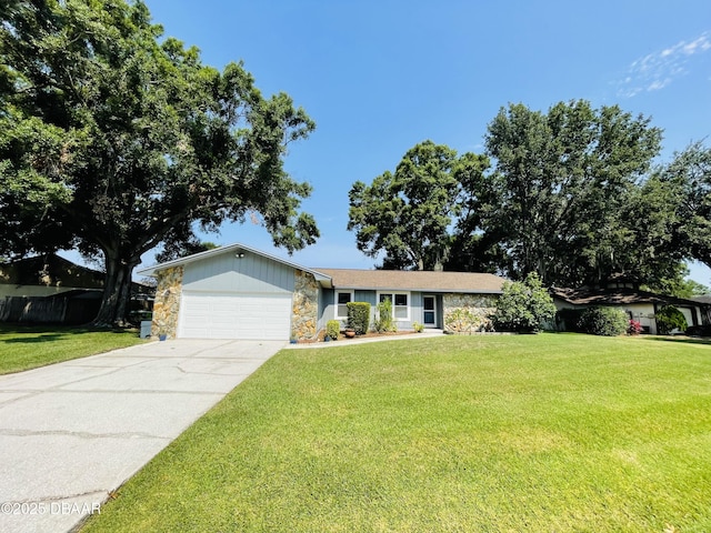3565 E Lake Dr, Land Olakes, FL 34639 - ranch-style home with stone siding, a garage, a front yard, and driveway