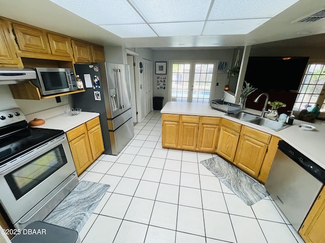 3565 E Lake Dr, Land Olakes, FL 34639 - kitchen featuring stainless steel appliances, a sink, light countertops, and a drop ceiling
