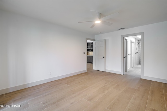 spare room with light wood-type flooring and ceiling fan