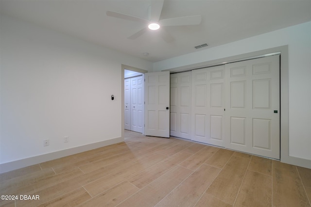 unfurnished bedroom featuring ceiling fan and light wood-type flooring