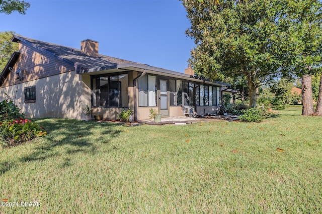 view of front of property with a front yard and a sunroom