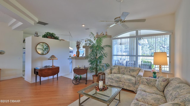 living room with ceiling fan and light hardwood / wood-style flooring