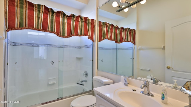 full bathroom featuring vanity, enclosed tub / shower combo, and toilet