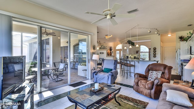 tiled living room featuring track lighting and ceiling fan