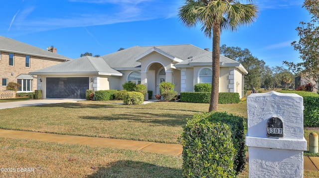 ranch-style home featuring a garage and a front lawn