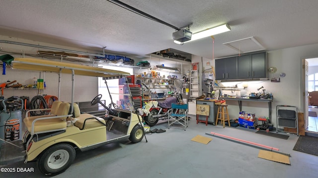 garage with a garage door opener and a workshop area