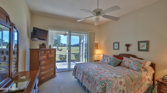 carpeted bedroom with ceiling fan and access to exterior