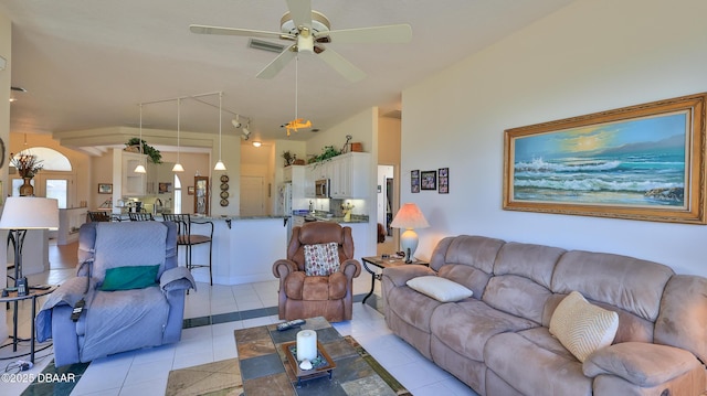 tiled living room featuring ceiling fan