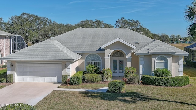 ranch-style home with french doors, a garage, and a front lawn