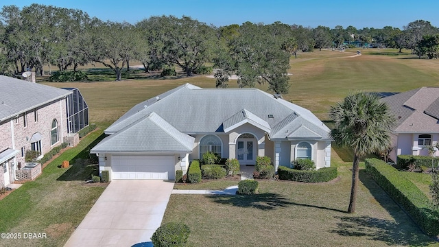 view of front of home with a garage, a front yard, and glass enclosure