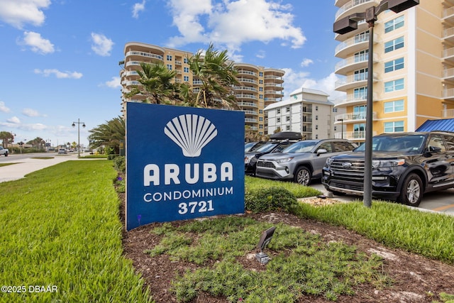 community sign featuring a lawn