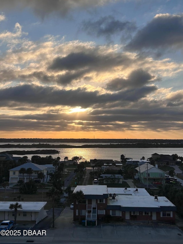 aerial view at dusk with a water view