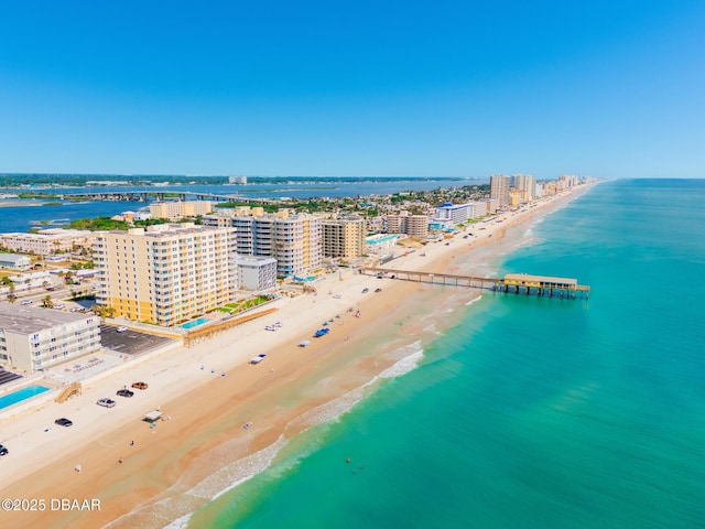 drone / aerial view featuring a beach view and a water view