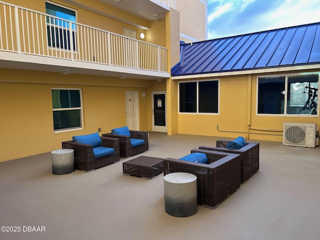 view of patio / terrace featuring ac unit, an outdoor hangout area, and a balcony