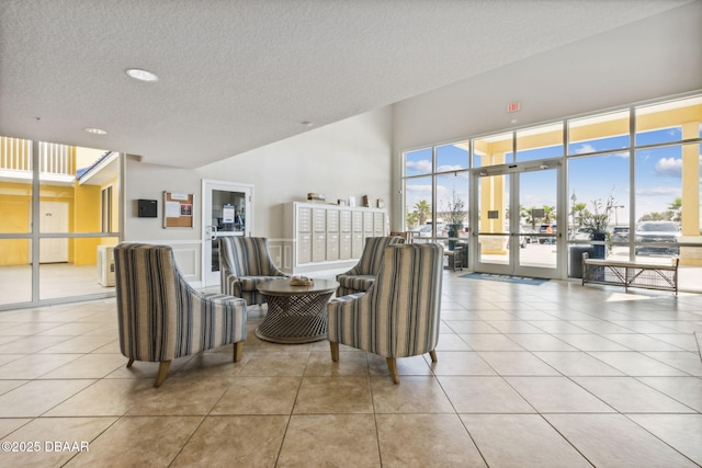 living room with light tile patterned flooring and a textured ceiling