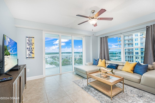 living room featuring ceiling fan and light tile patterned flooring