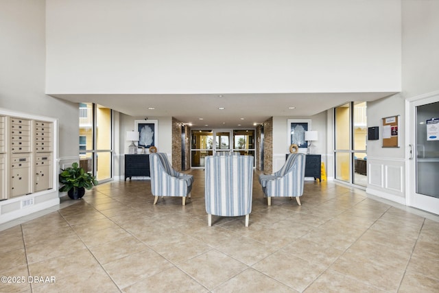 unfurnished living room featuring a mail area and light tile patterned flooring