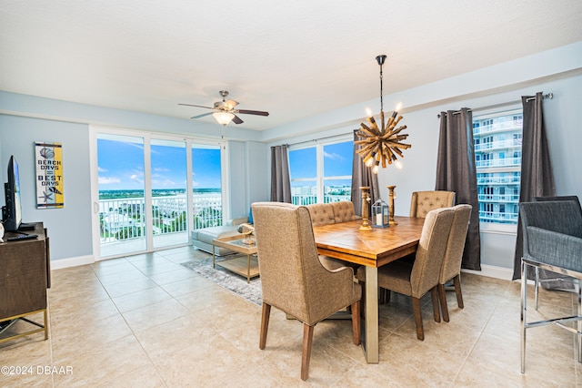 tiled dining space featuring a wealth of natural light and ceiling fan