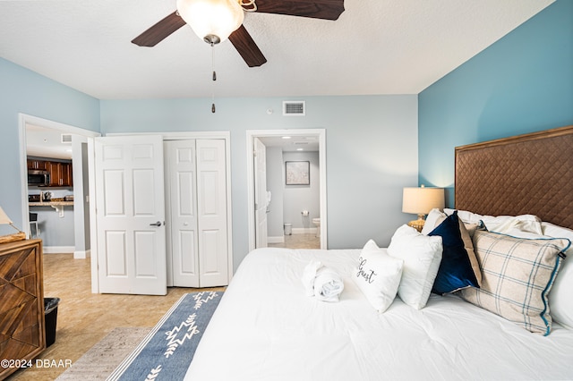 bedroom featuring connected bathroom, ceiling fan, and a closet