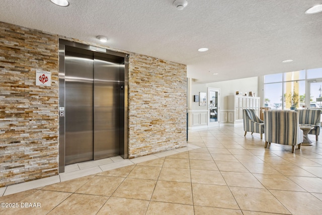 kitchen with elevator and light tile patterned flooring