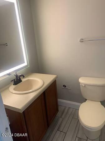 800 N Atlantic Ave Unit 508, Daytona Beach, FL 32118 - bathroom with vanity, toilet, and baseboards