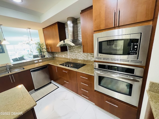 1925 S Atlantic Ave Unit 411, Daytona Beach Shores, FL 32118 - kitchen featuring appliances with stainless steel finishes, wall chimney exhaust hood, a sink, brown cabinets, and hanging light fixtures