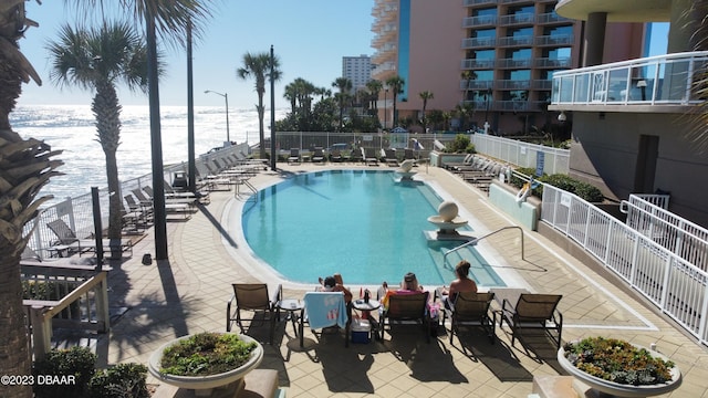 1925 S Atlantic Ave Unit 411, Daytona Beach Shores, FL 32118 - community pool with view of water and beach and a patio area