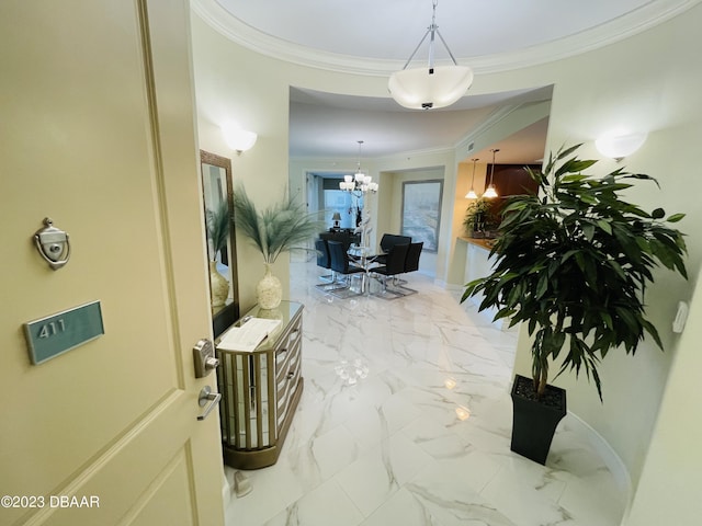 1925 S Atlantic Ave Unit 411, Daytona Beach Shores, FL 32118 - hall with a chandelier, ornamental molding, marble finish flooring, and baseboards