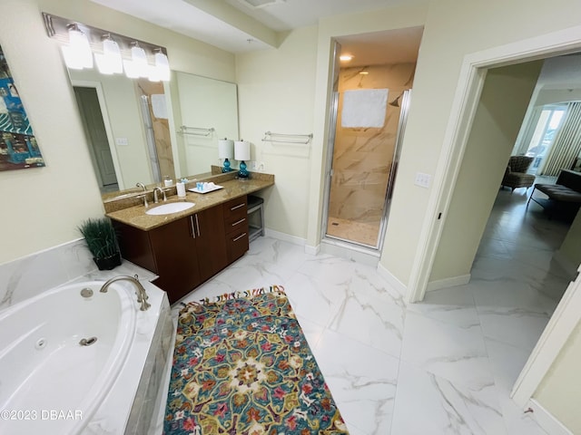 1925 S Atlantic Ave Unit 411, Daytona Beach Shores, FL 32118 - bathroom featuring a tub with jets, vanity, a stall shower, marble look tiles, and baseboards